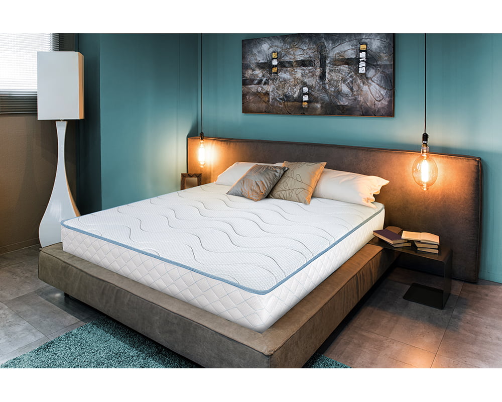 View of double bed in cozy interior