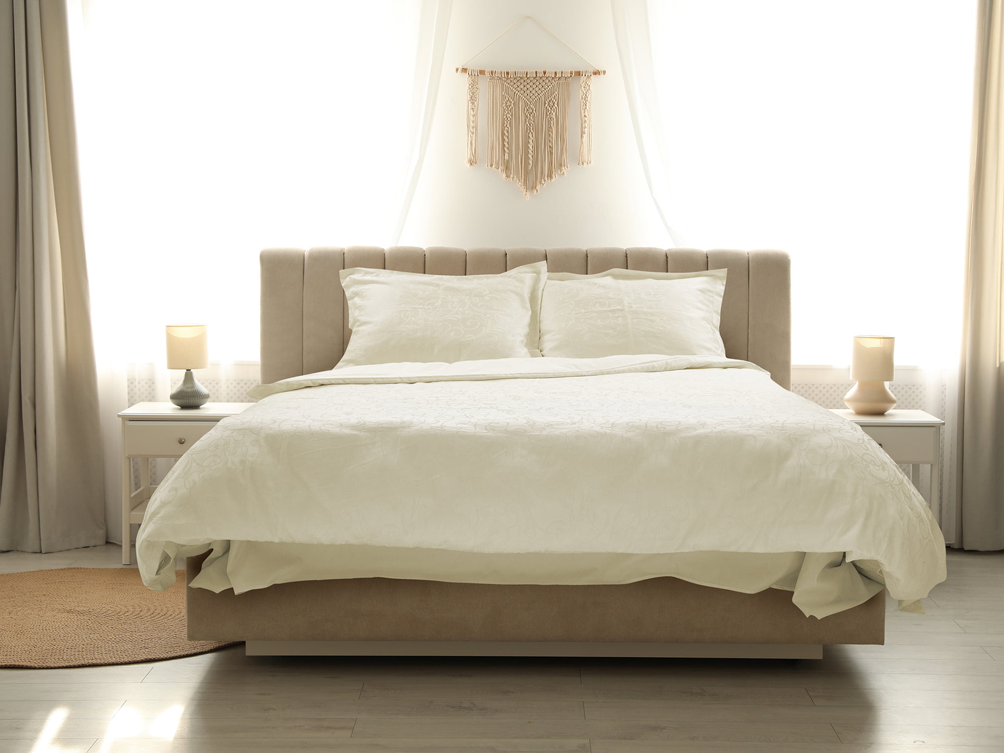 Comfortable bed with soft blanket in stylish room interior